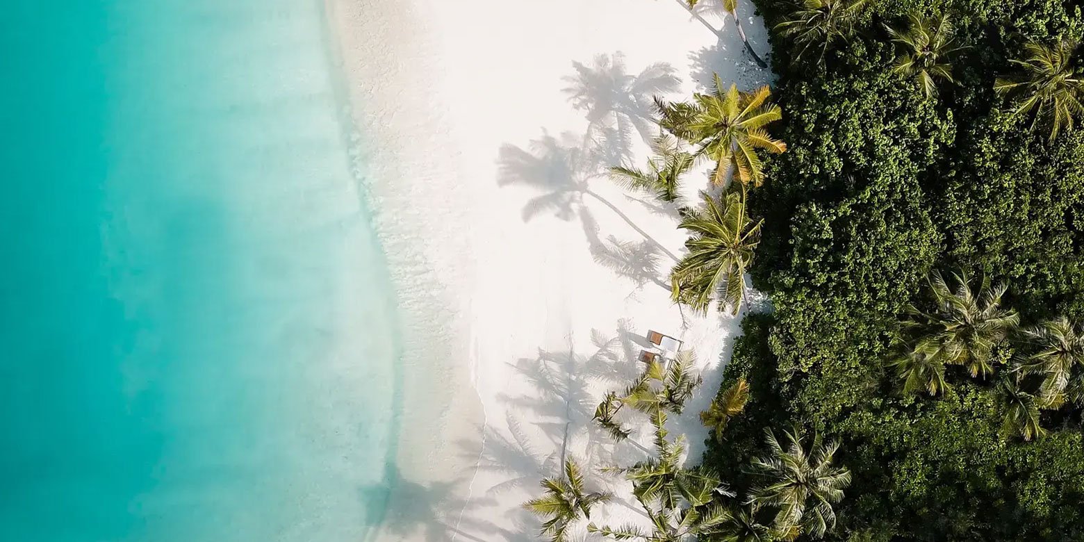 Aerial view of a beach and clear blue water