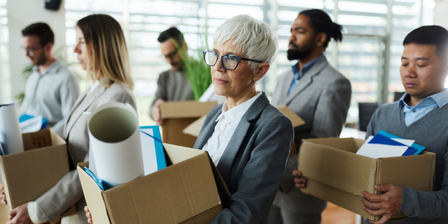 Unhappy senior leaving office with a box