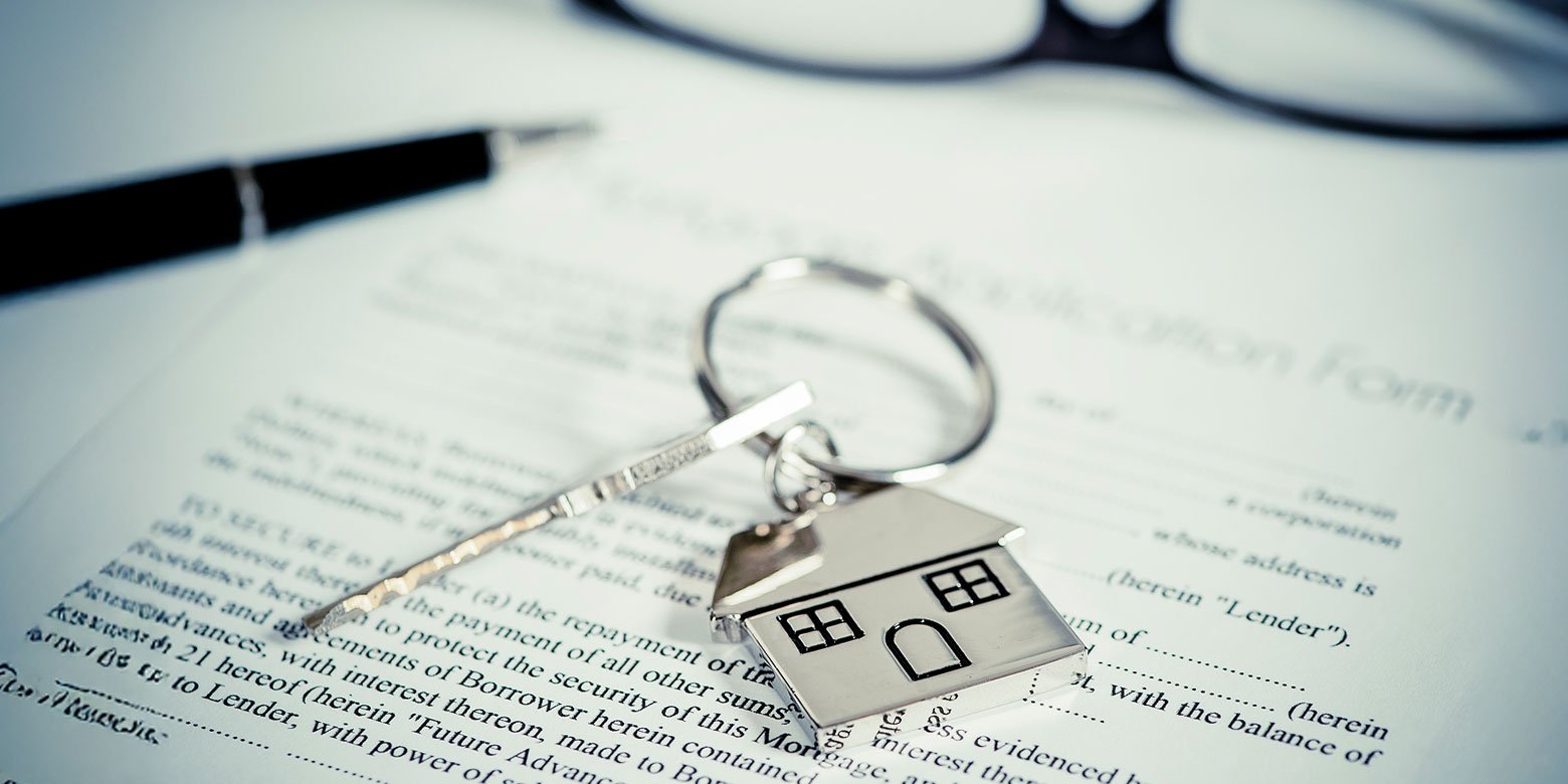 House key sitting on closing papers