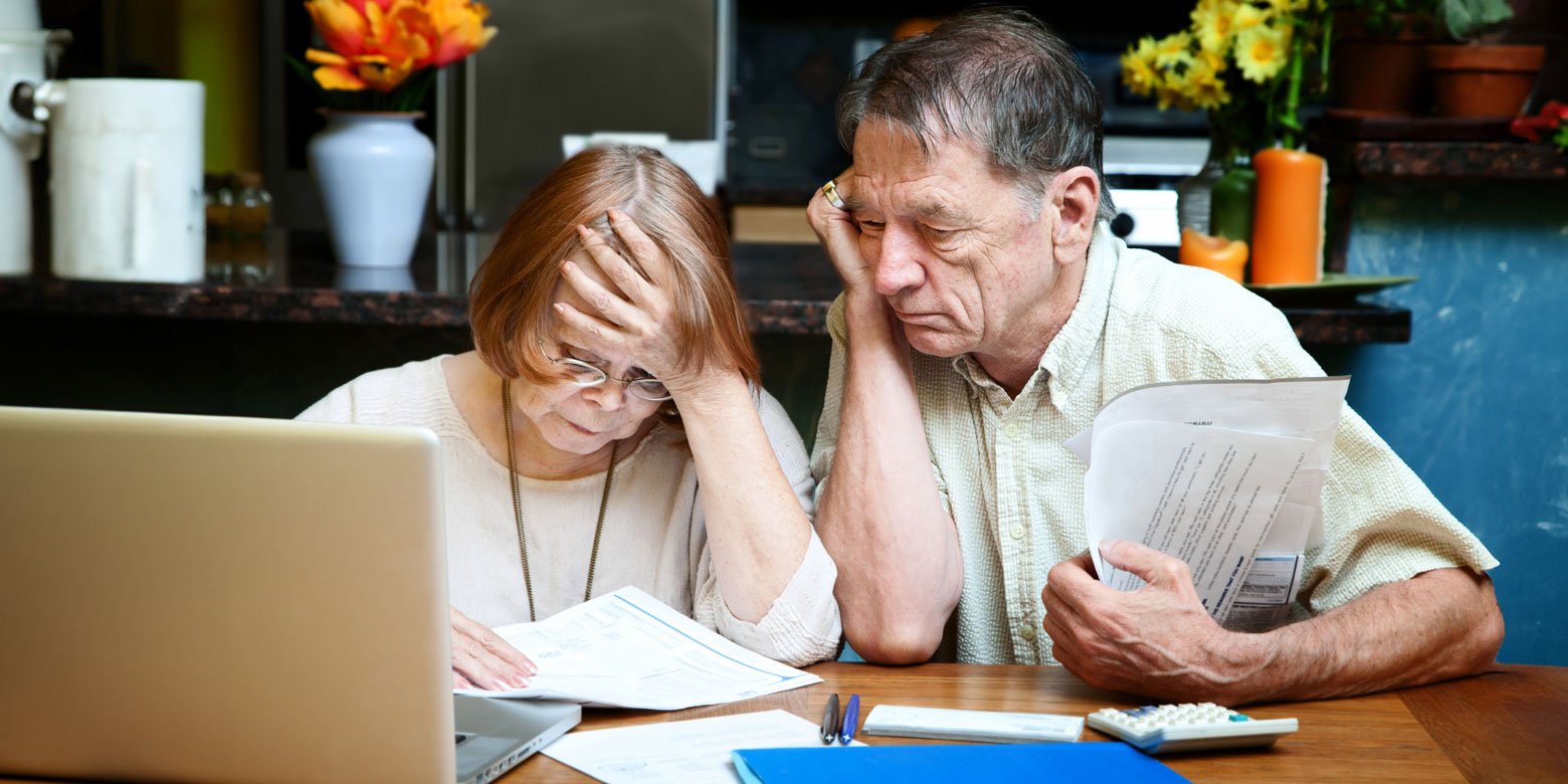 Older couple stressing over paperwork