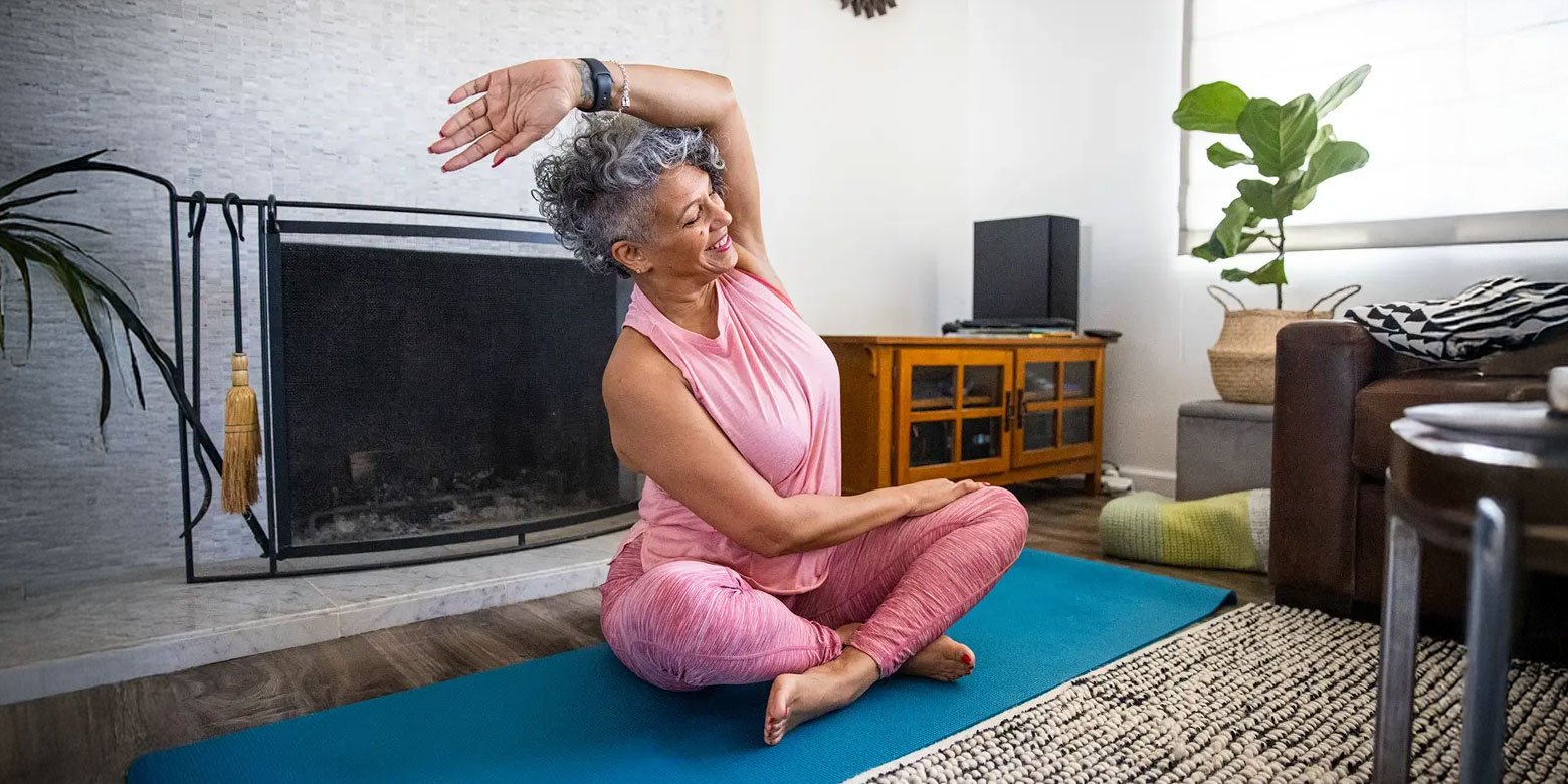 Senior woman exercising on a mat