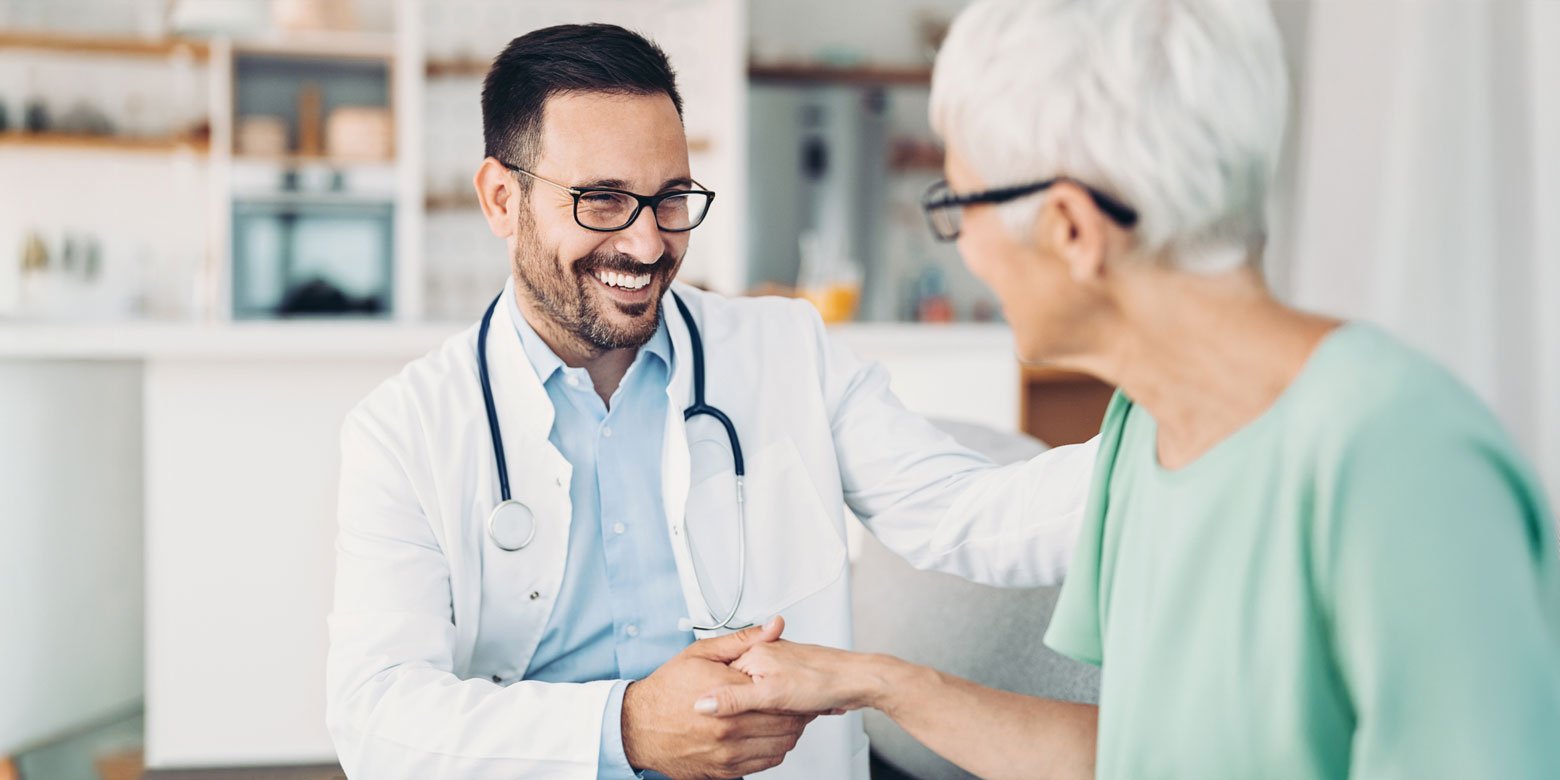 Doctor assisting an elderly person