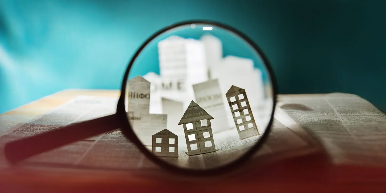 Magnifying glass looking at homes and buildings