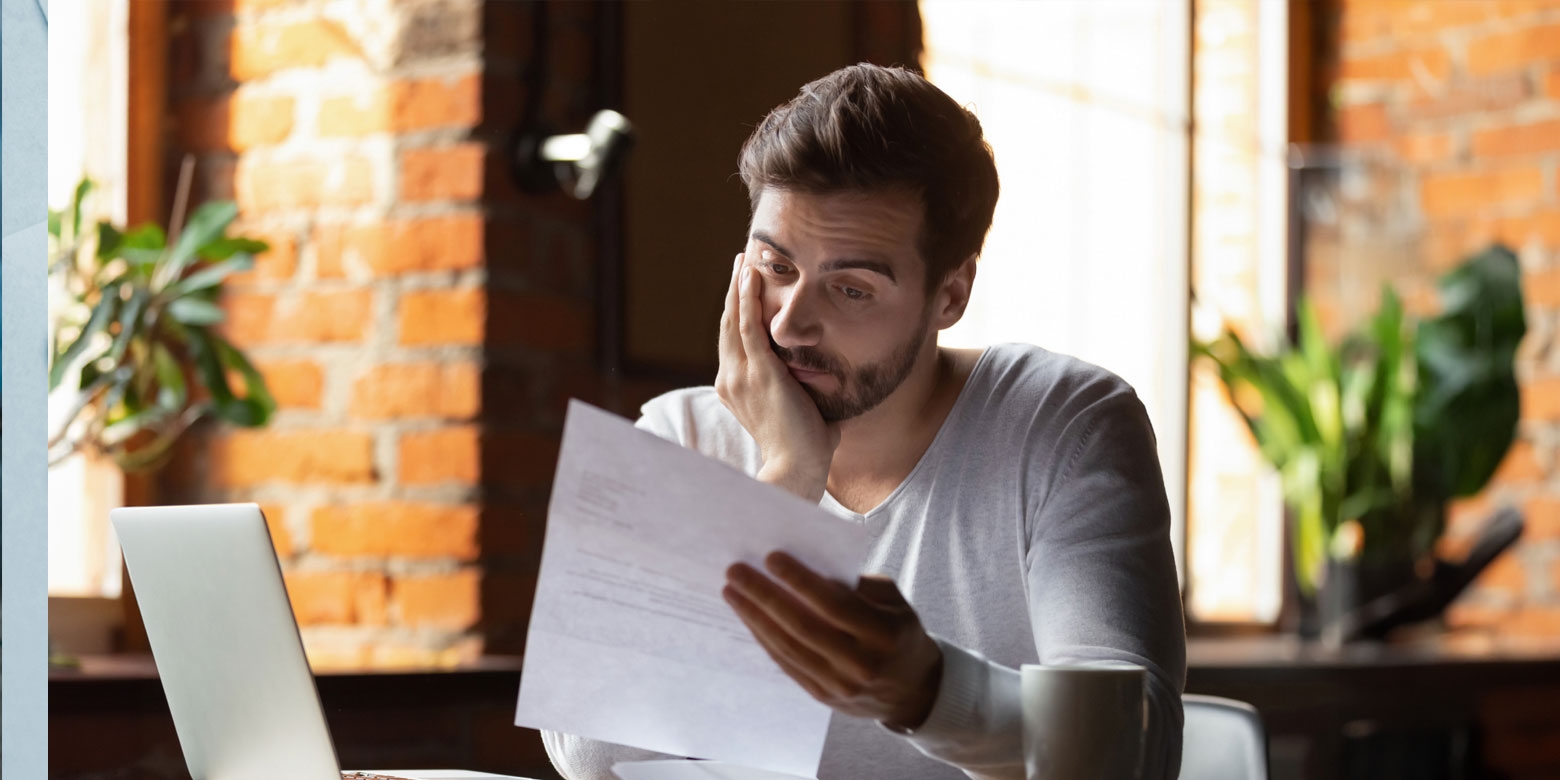 Man worried looking over paperwork