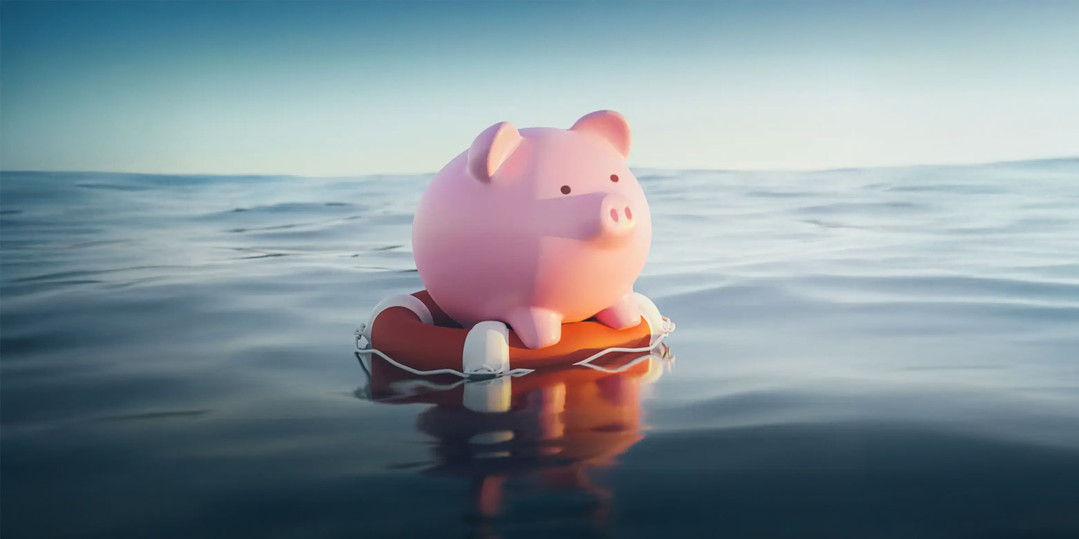 A piggy bank floating on a life preserver in the ocean