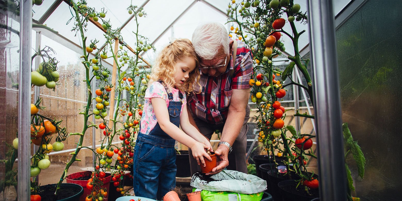 Child and grandparent gardening