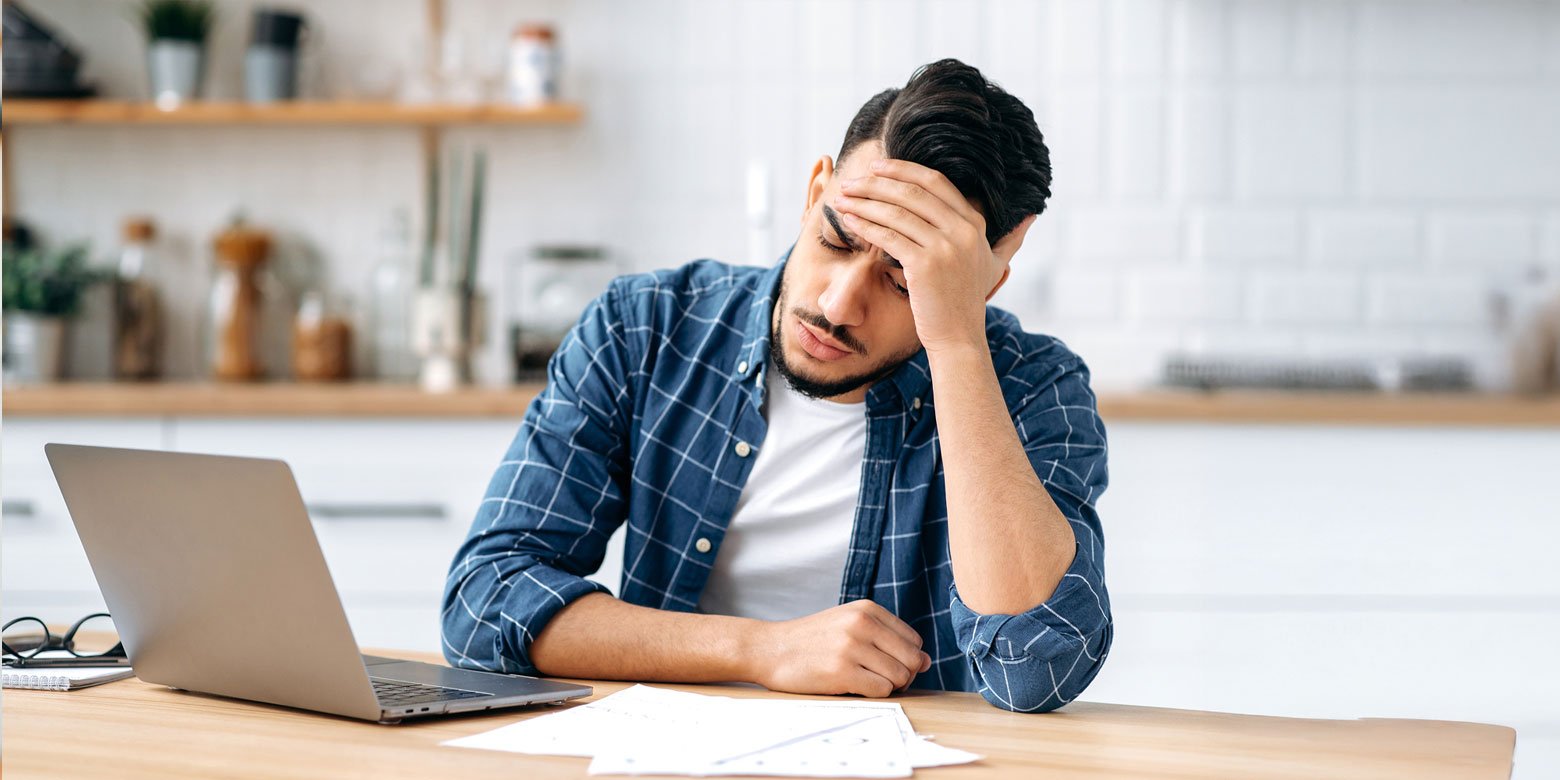 Man holding his forehead looking stressed