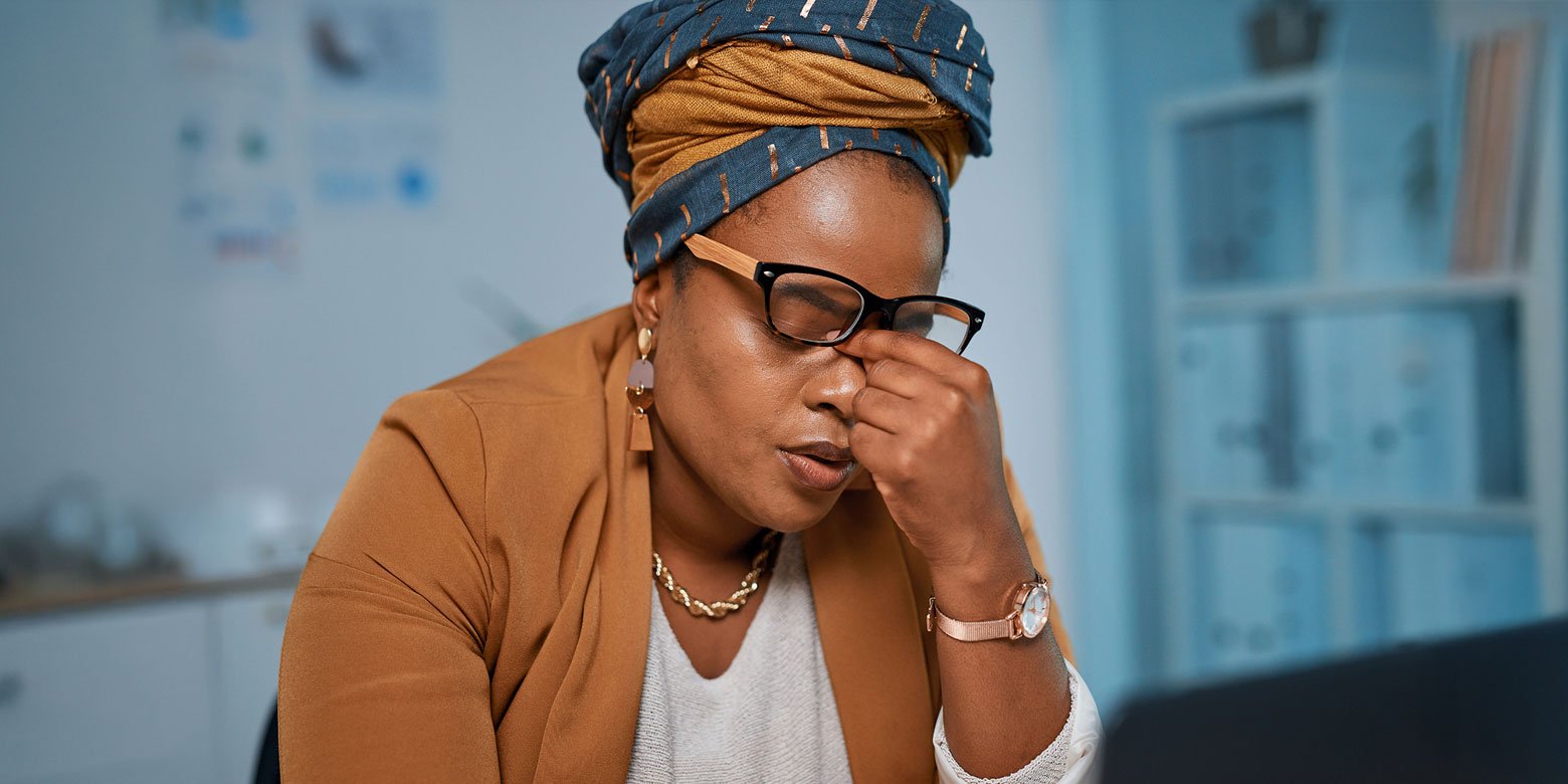 Stressed woman rubbing her eyes
