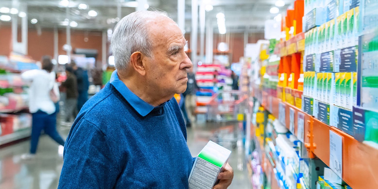 Elderly man shopping for medication