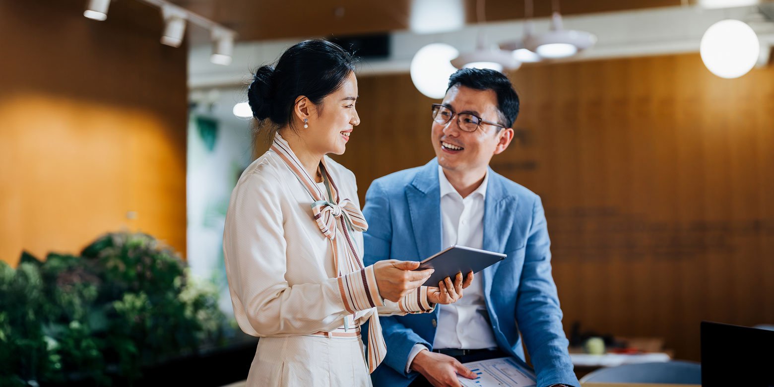 A life insurance agent talks through options with a client.