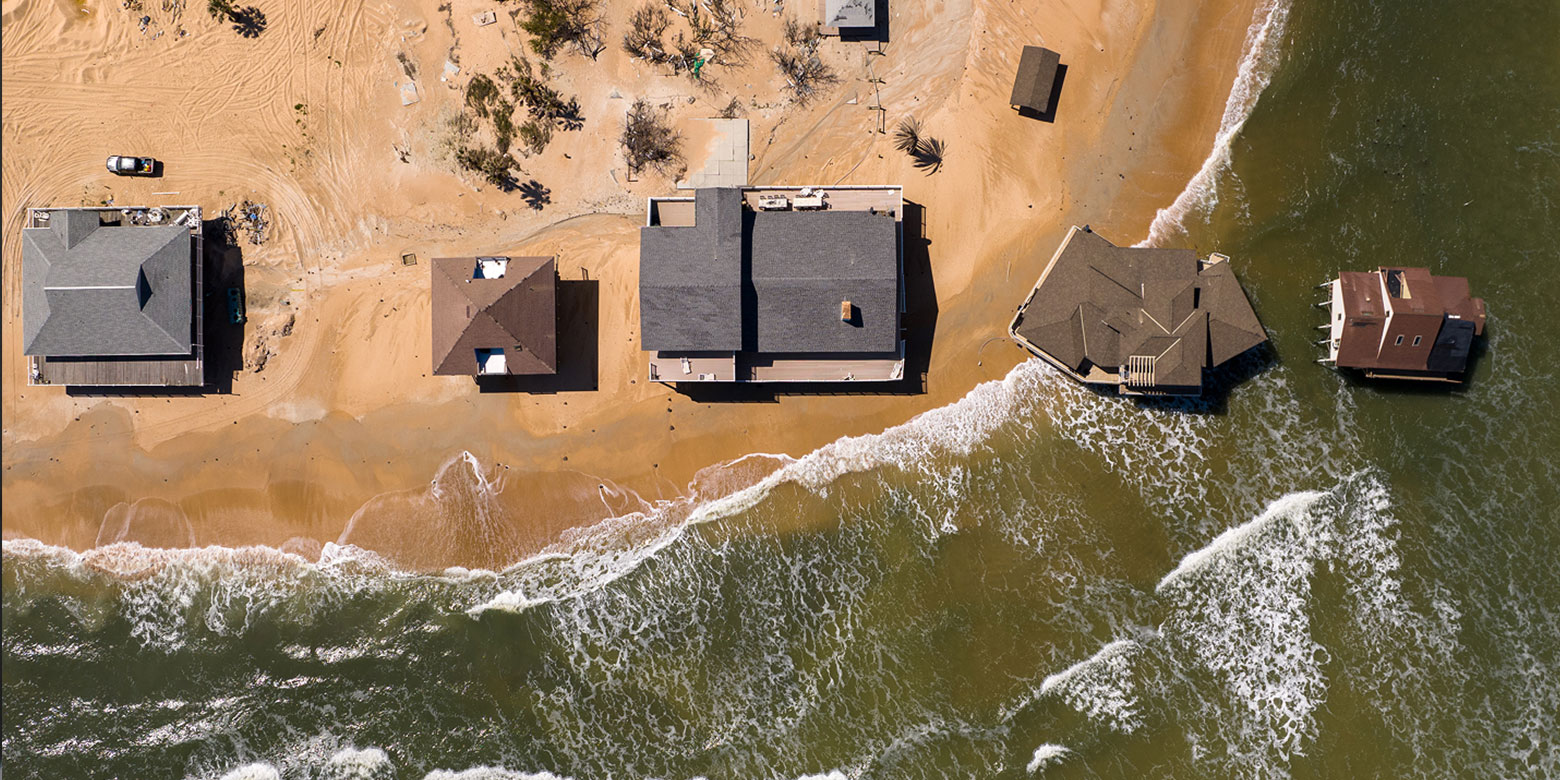 Aerial view of beach houses with eroding shore line