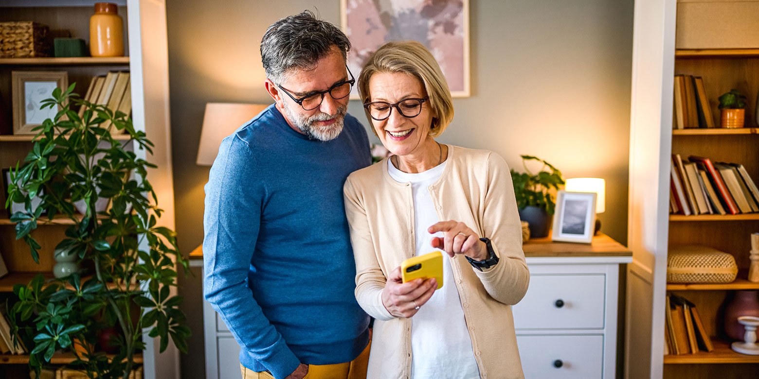 Middle aged couple looking at phone