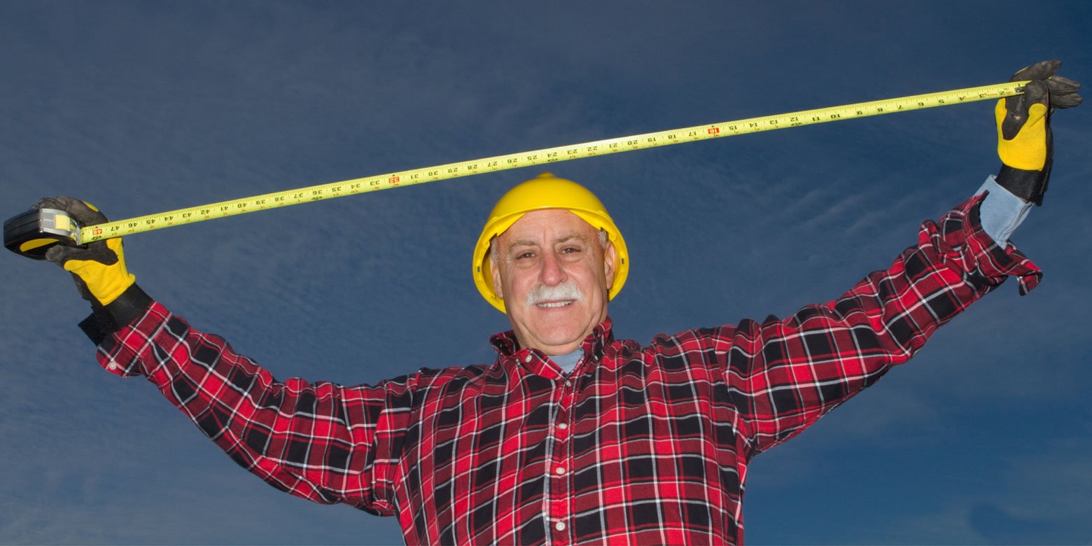 Man stretching tape measure